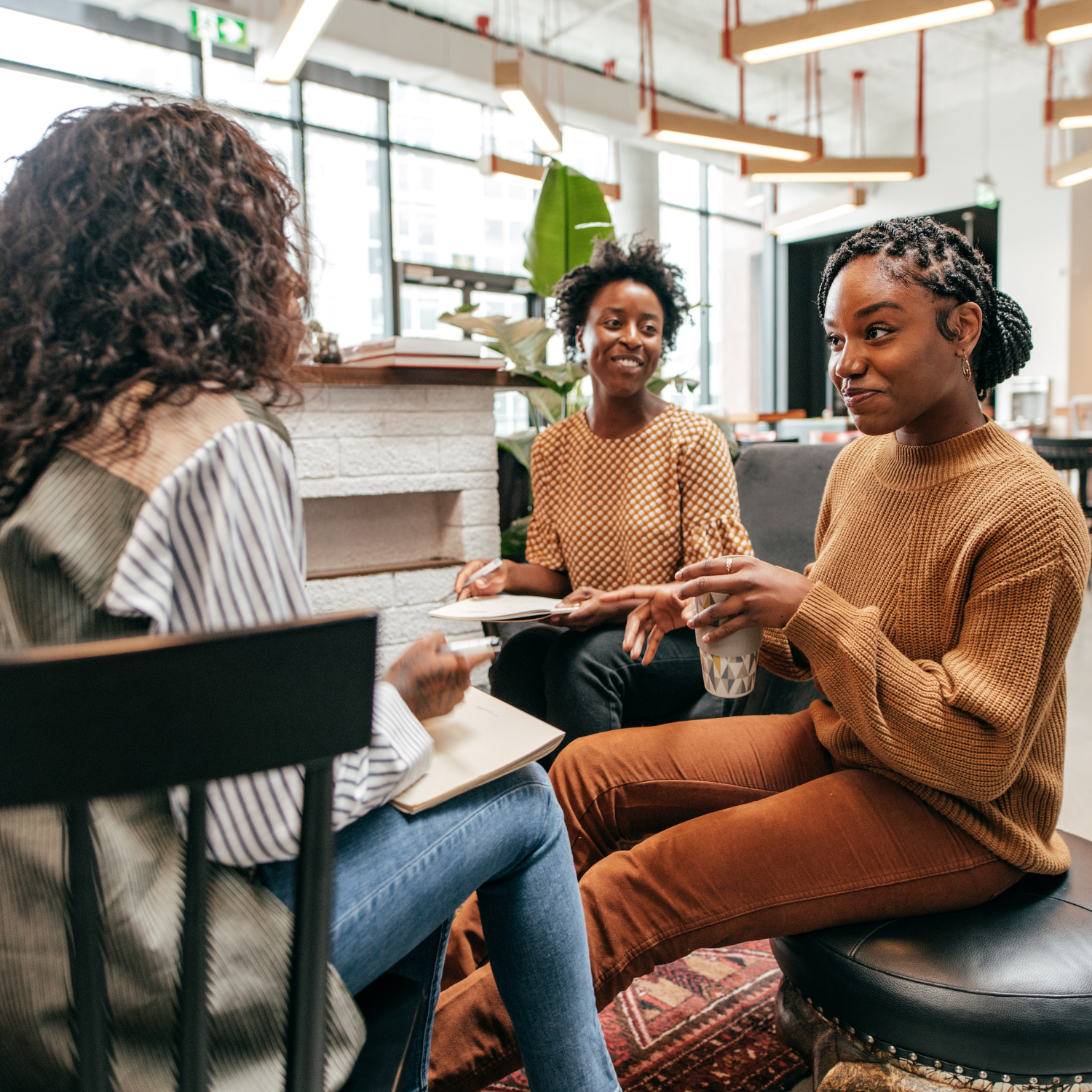 Three women in discussion while seated